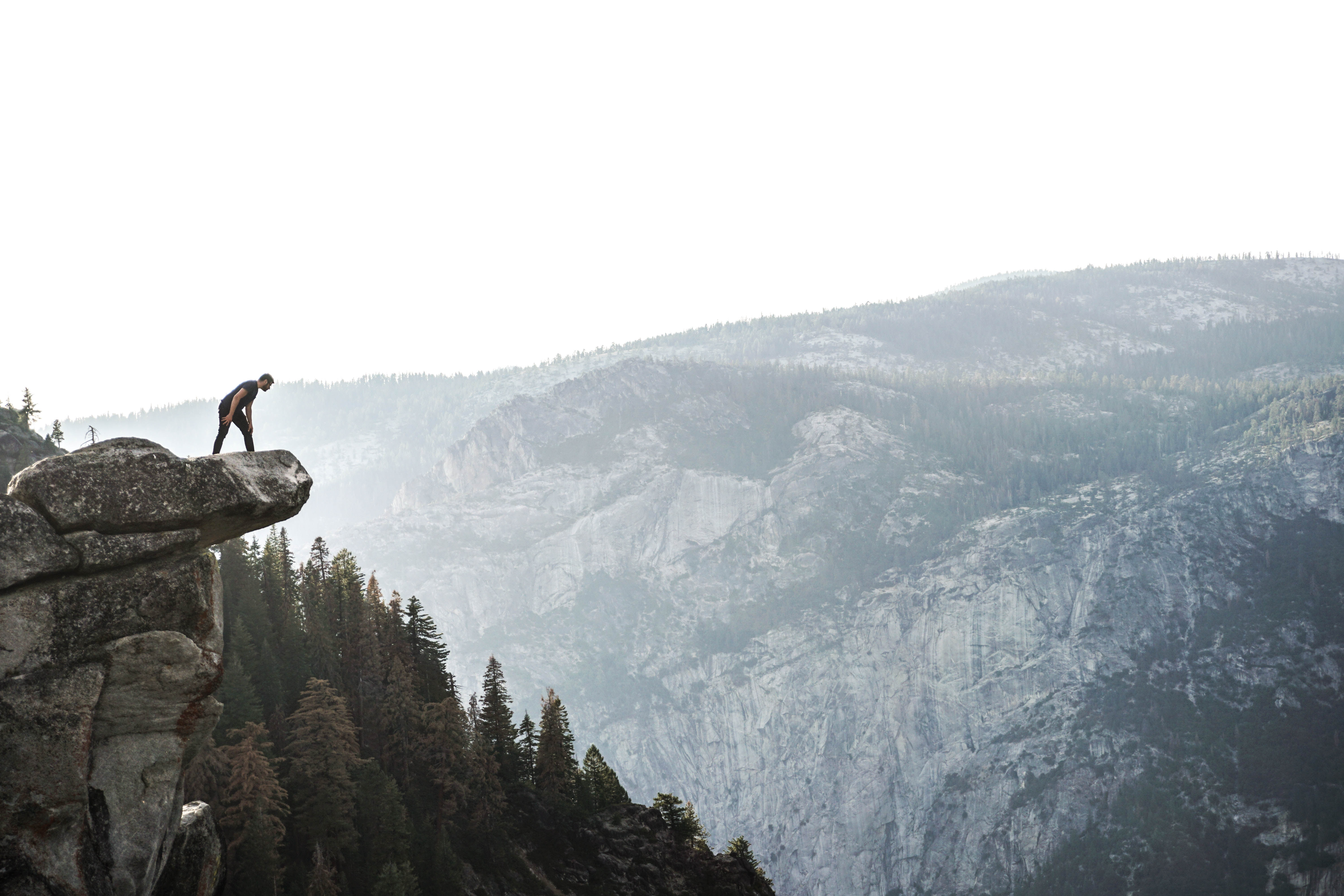 Man looking over cliff